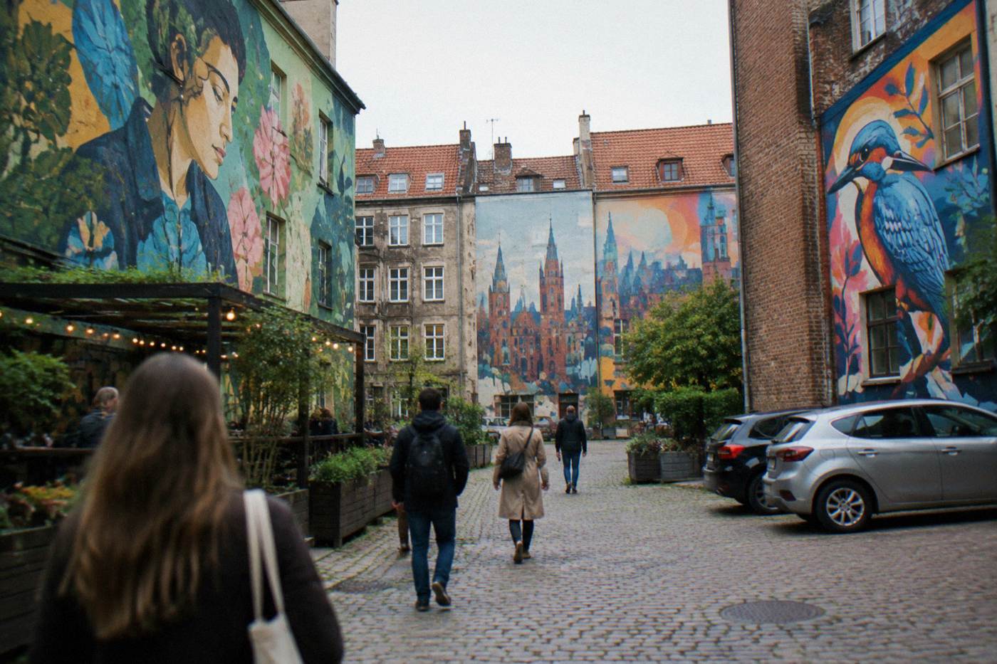 Colorful contemporary murals painted on the walls of a revived city courtyard