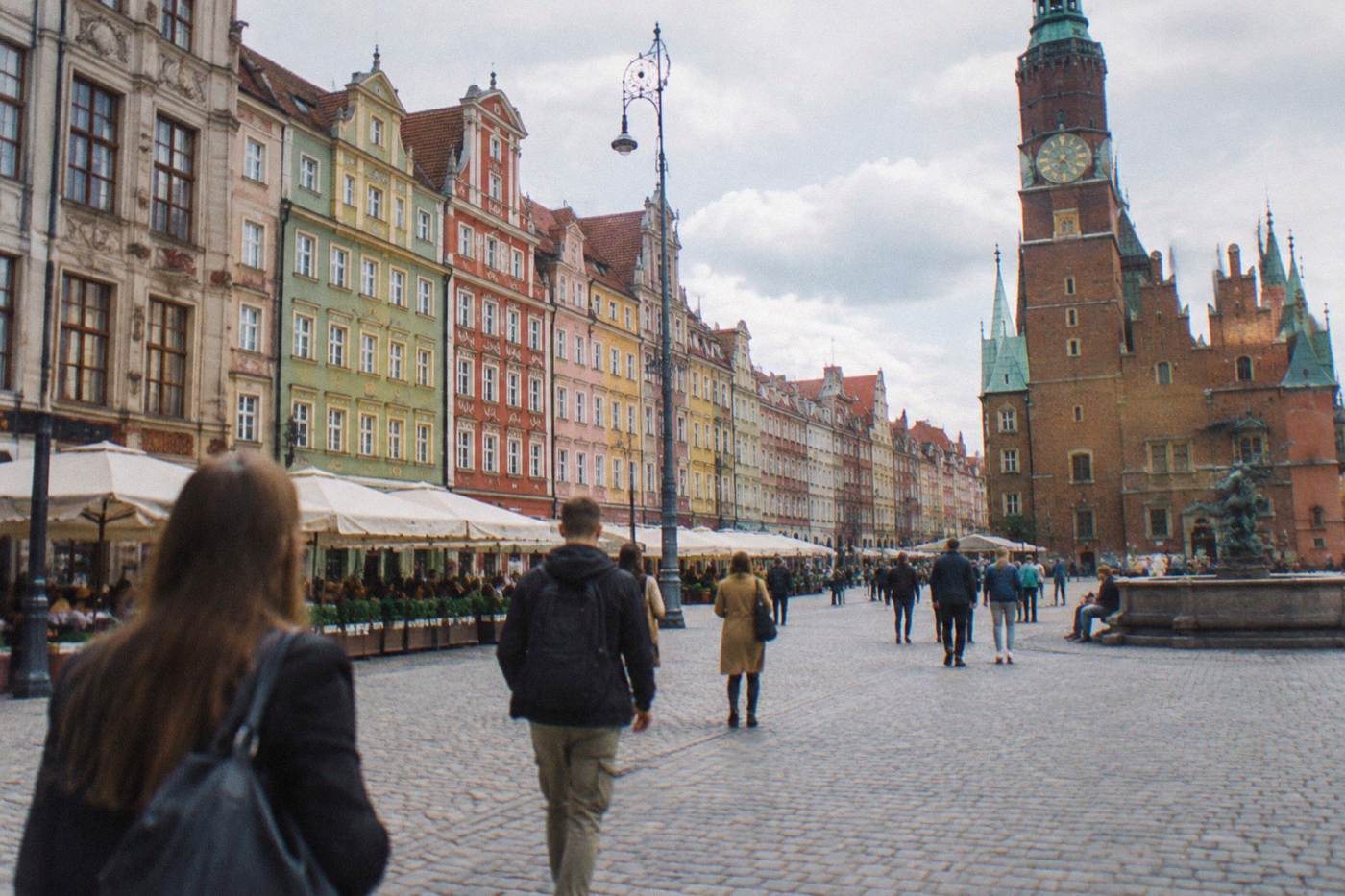 Colorful townhouses lining Wroclaw market square on a bright afternoon