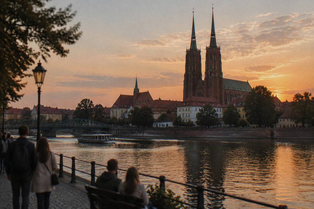 Gothic cathedral towers of Ostrow Tumski seen across the Odra river at dusk