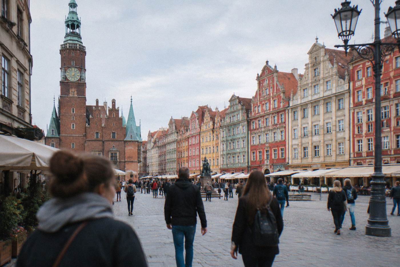 Wroclaw's Market Square lined with colorful townhouses on a bright day