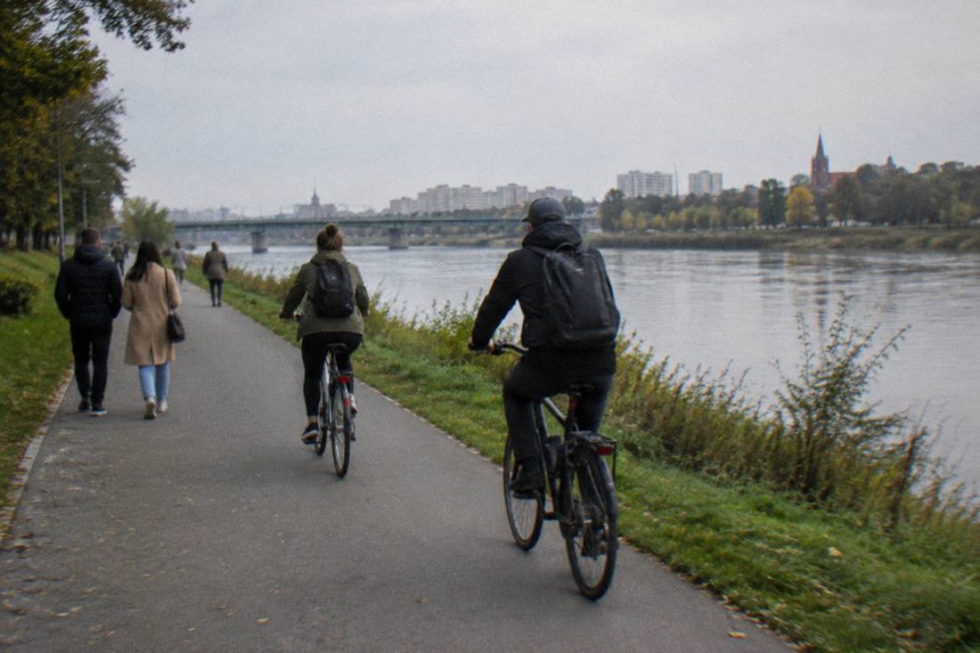 Cyclists and pedestrians on a flat riverside path along the Odra in eastern Wroclaw