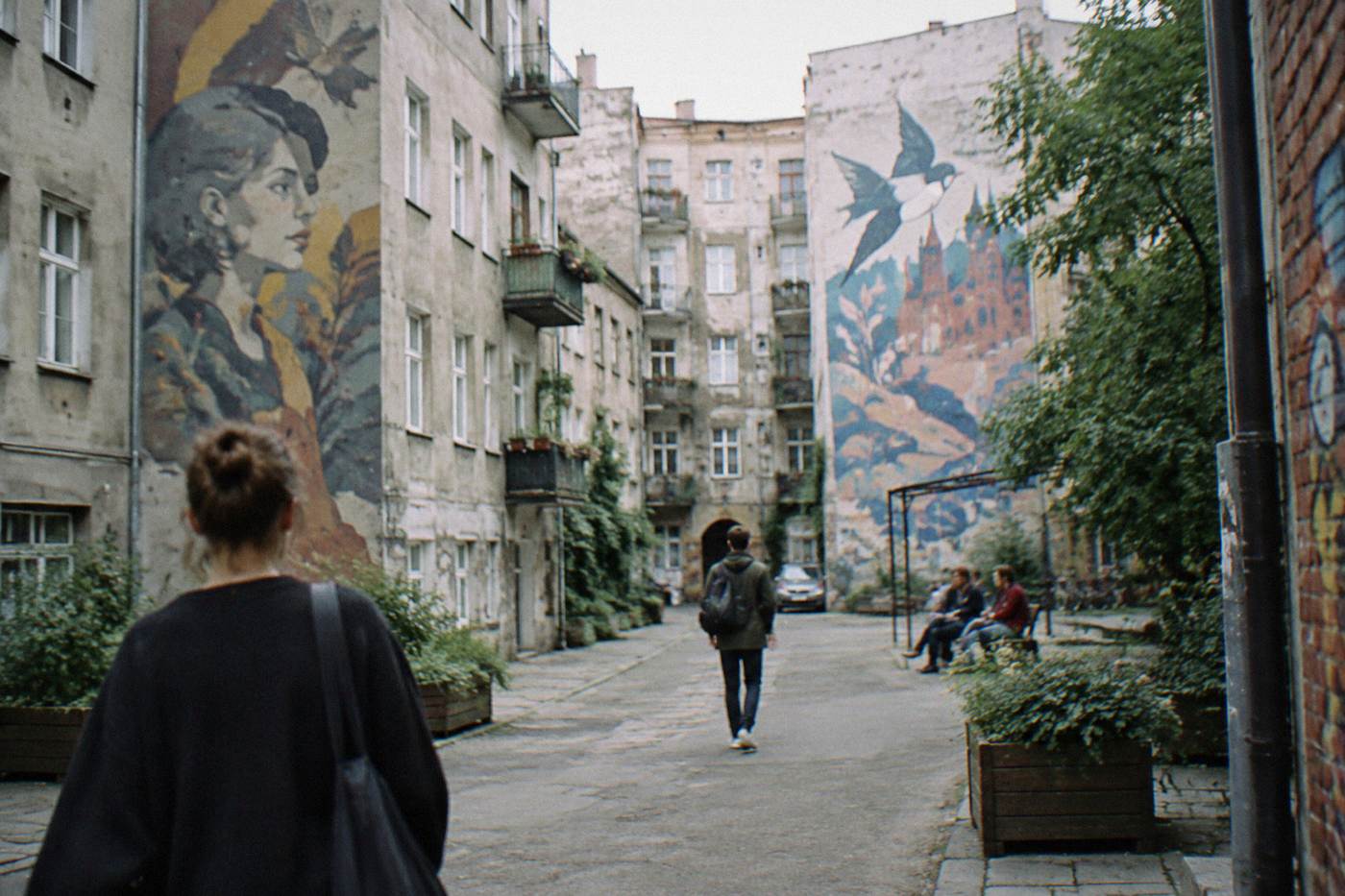 Old apartment buildings in a revitalized city district with painted murals on courtyard walls