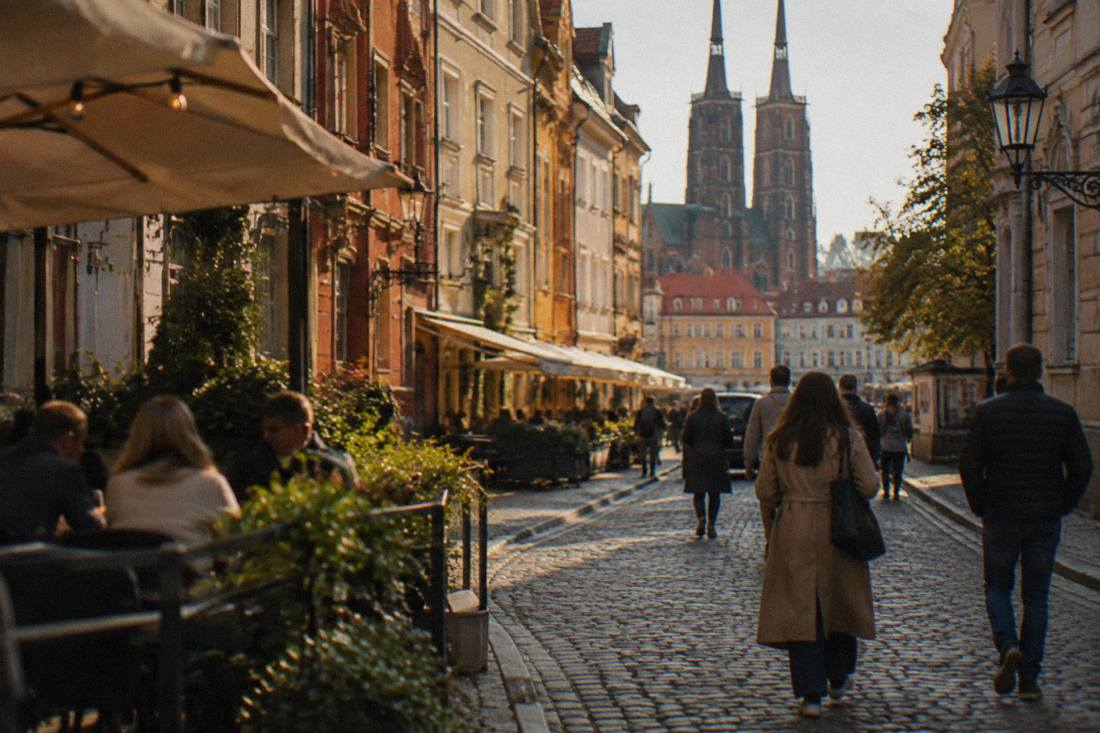 A narrow cobblestone lane in Old Town Wroclaw with cafes and old merchant houses