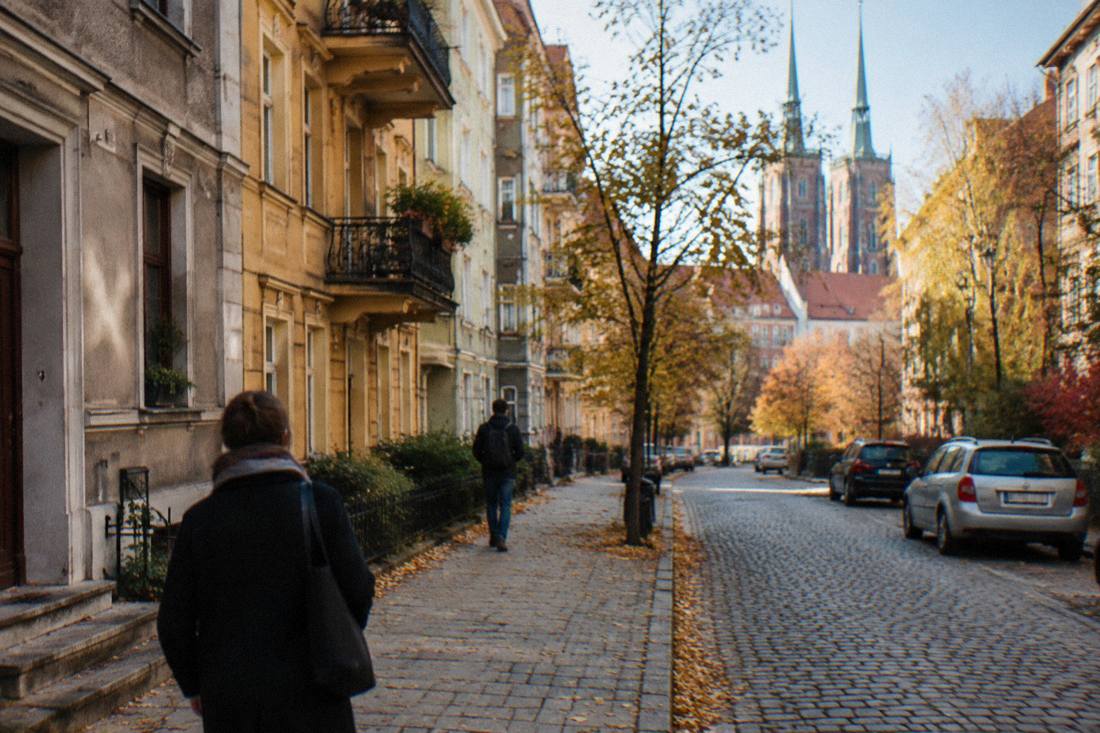 A quiet residential street with old apartment buildings near the Old Town of Wroclaw