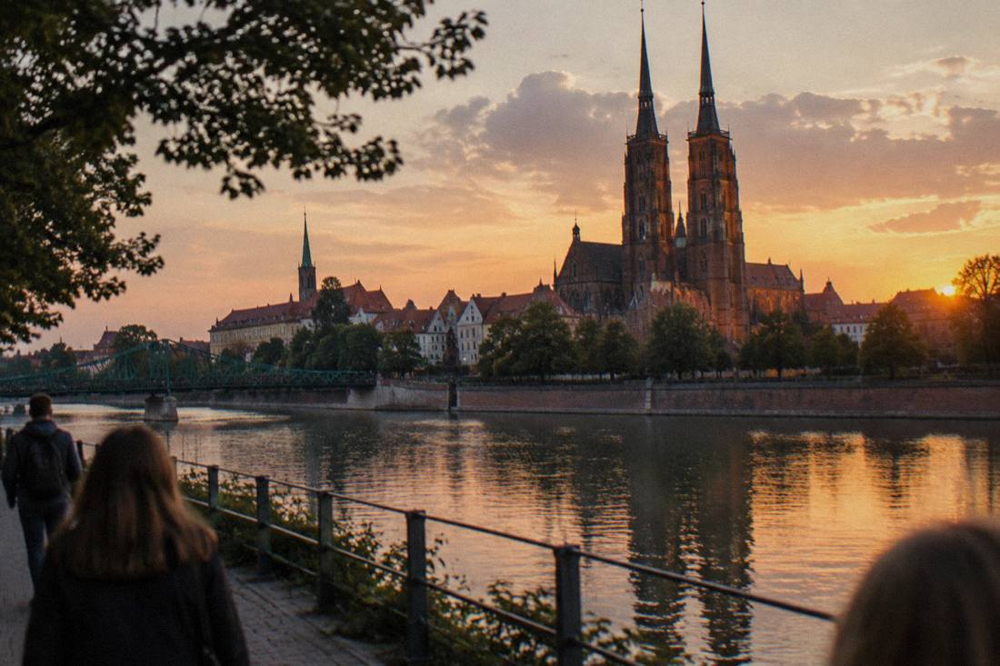 The gothic cathedral on Ostrów Tumski island seen across the Odra river at dusk