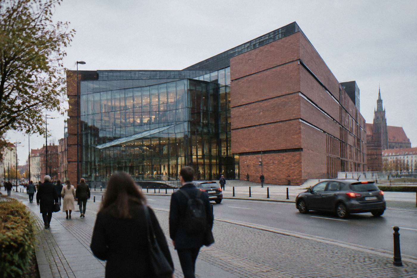 A modern concert hall building in central Wroclaw with glass and brick facade