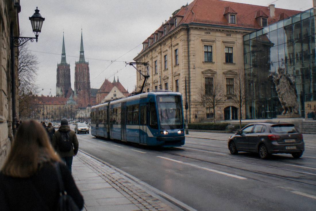 A tram moving along a street in central Wroclaw near the museum district