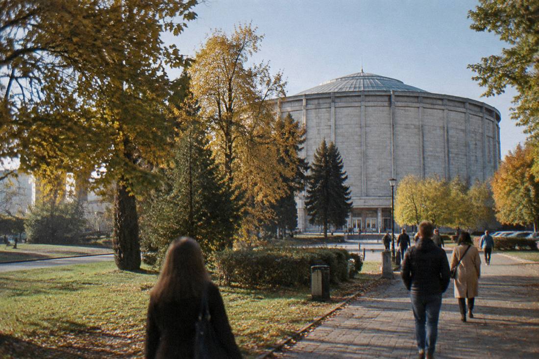 The exterior of the circular rotunda building surrounded by trees and a path
