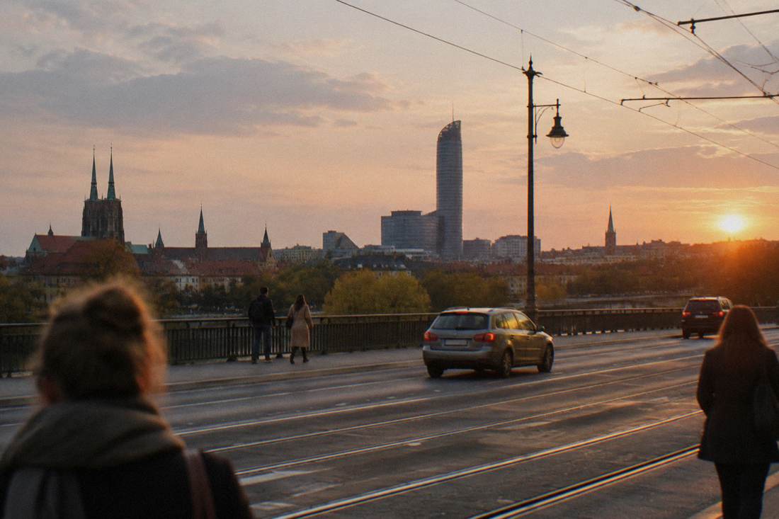 The tower seen from across rooftops with tram tracks in the foreground