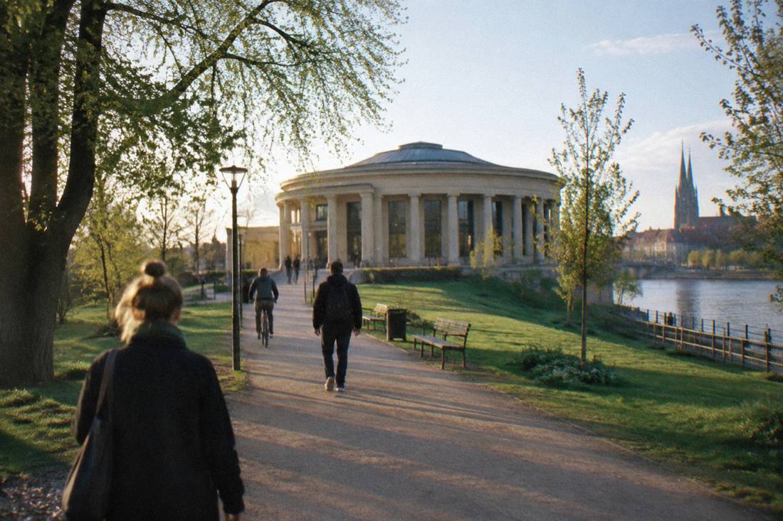 A circular panorama building with a columned portico seen across a park, with a path leading toward it