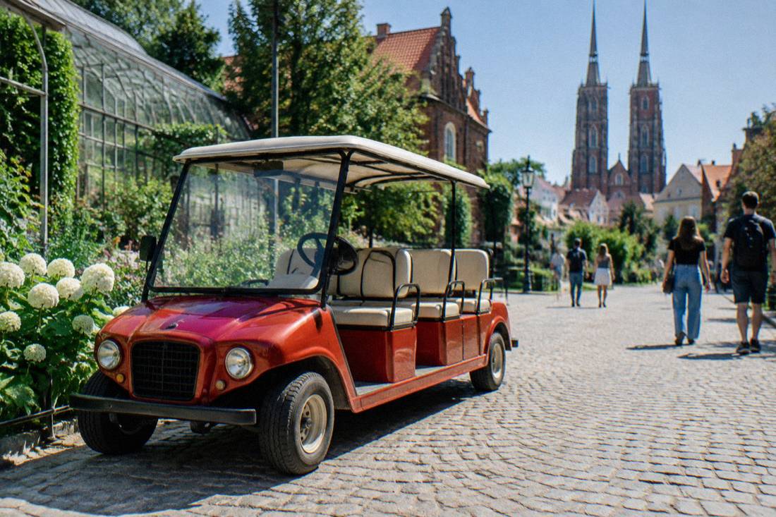 A red retro golf cart parked on a cobblestone street in an old European city center