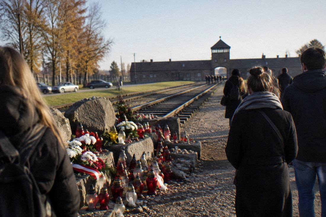 Candles and memorial stones placed at the end of the railway line at the former Birkenau site