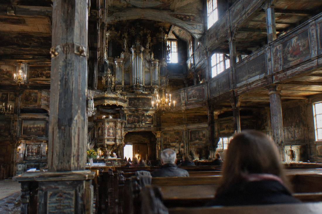 The painted wooden interior of the Church of Peace with its galleries and organ