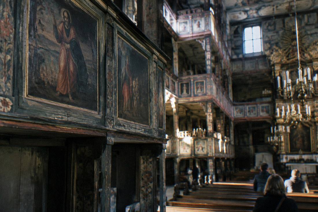 Close view of painted panels and wooden balconies inside the Church of Peace
