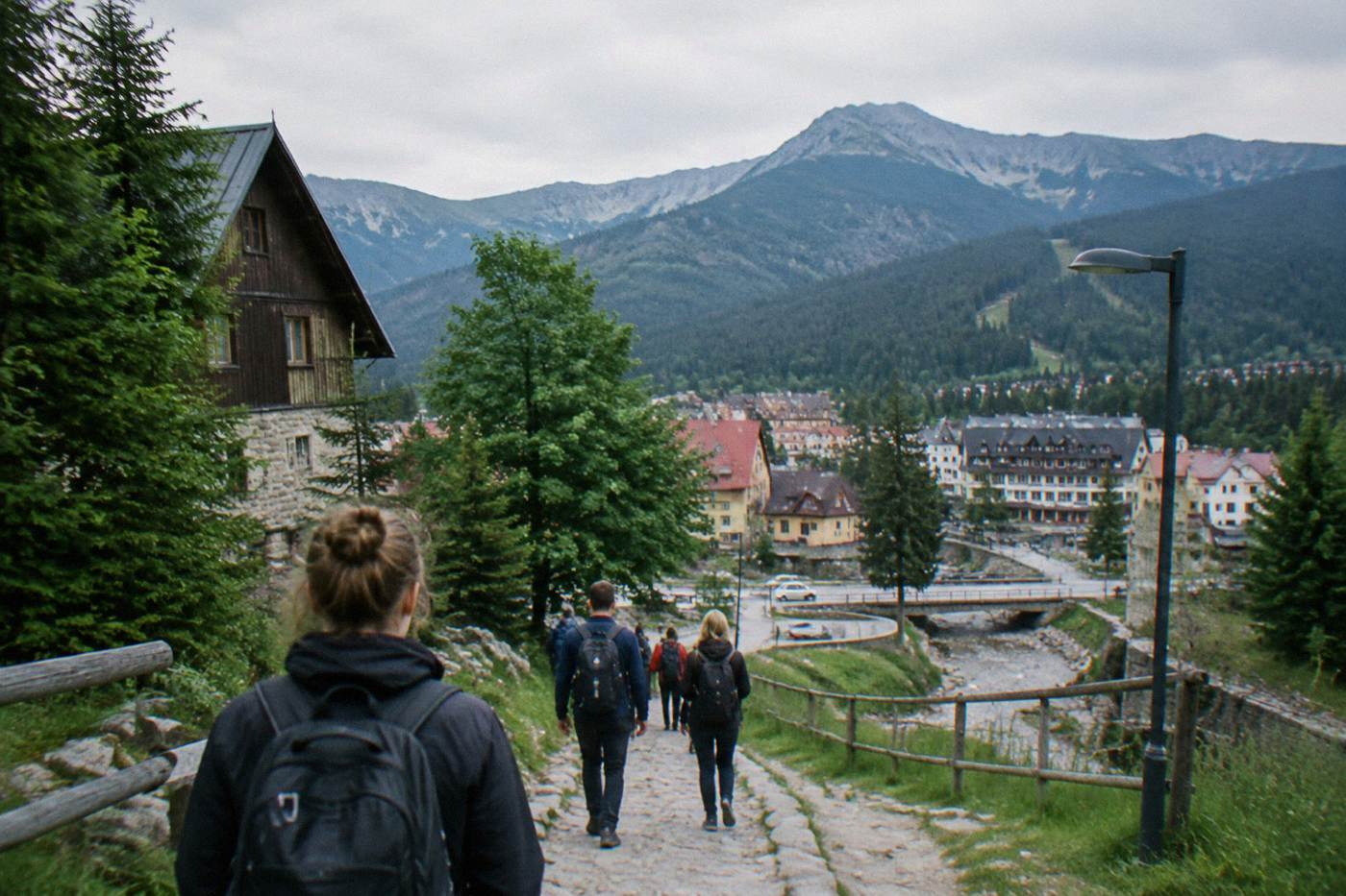 Mountain town streets with forested slopes rising behind the rooftops
