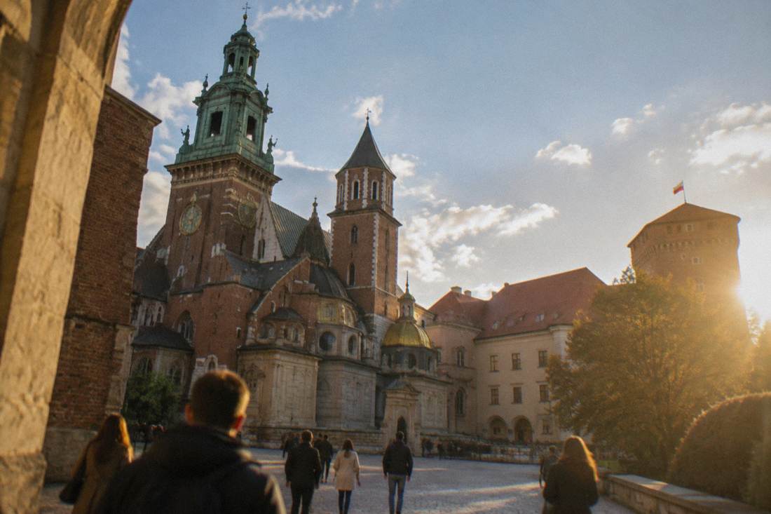 Wawel castle courtyard and cathedral tower seen from below on a bright day