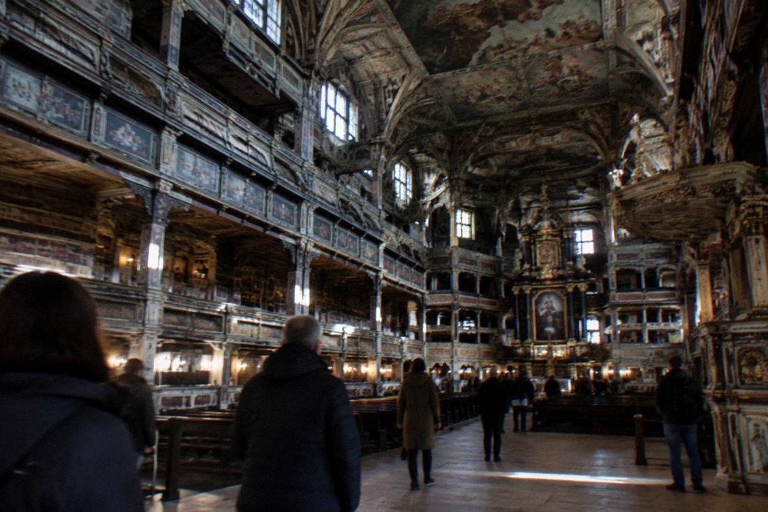 A vast timber-framed church interior with painted ceiling and galleries in Swidnica, Poland