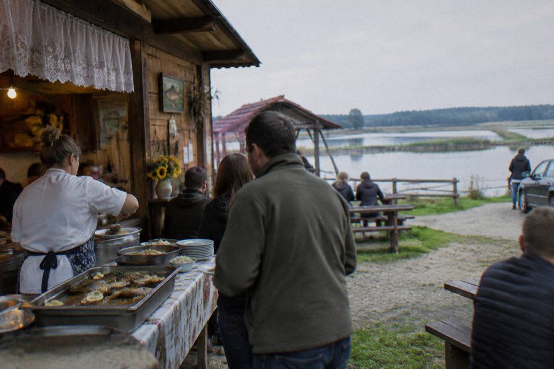 Traditional Polish country kitchen serving a carp lunch beside the ponds