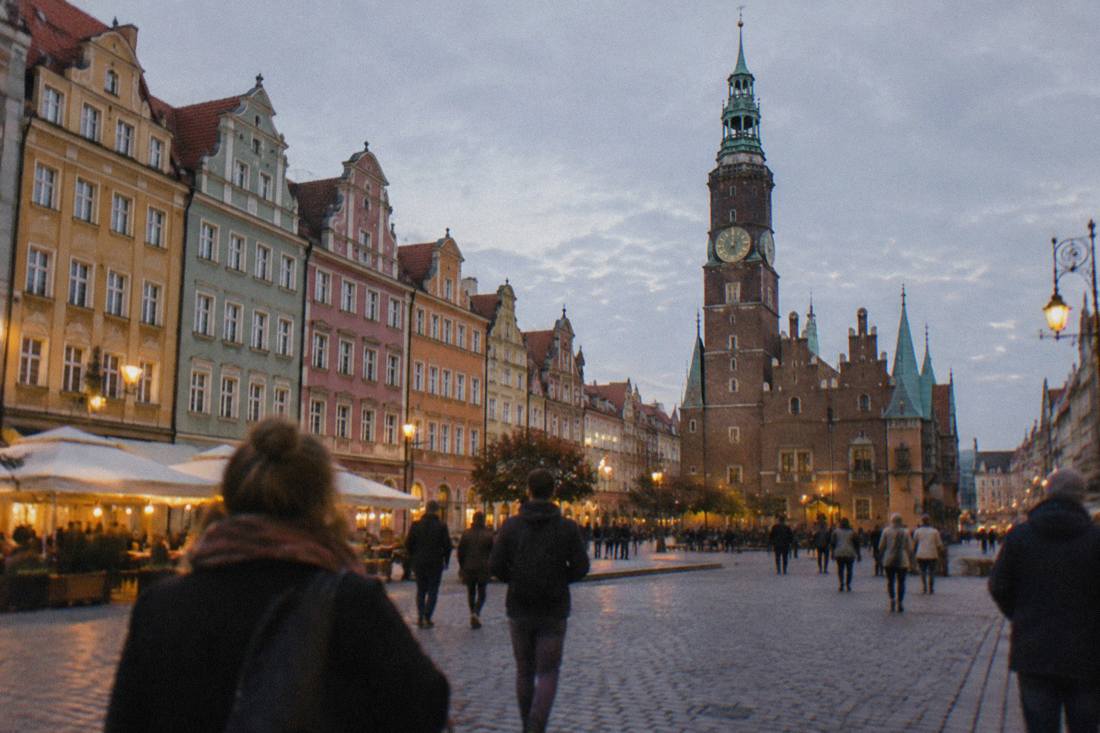 Wroclaw's colorful market square with gabled townhouses at dusk