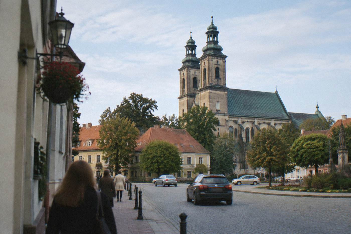 A small Lower Silesian town church townscape under a pale blue sky