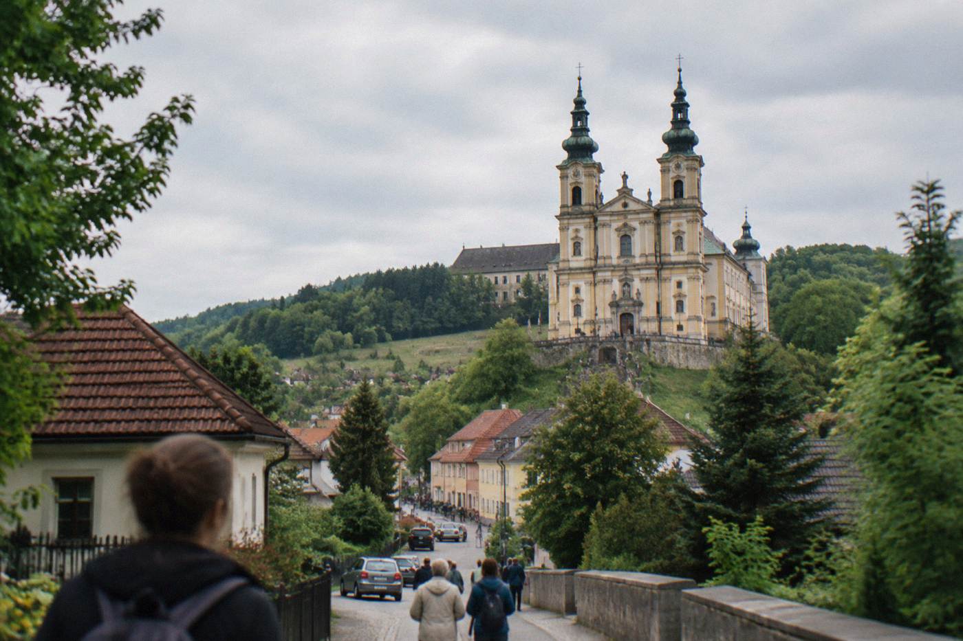 Baroque basilica towers rising above the small village of Wambierzyce among green hills