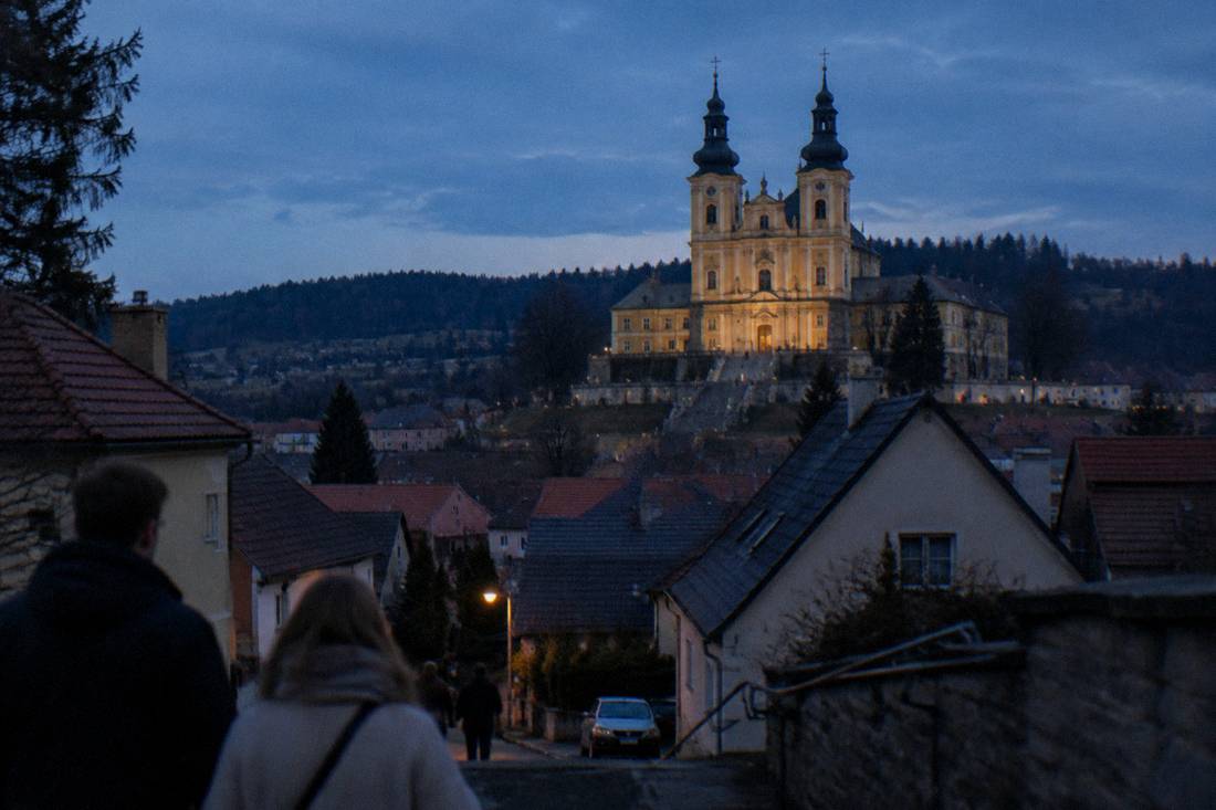 View over Wambierzyce village rooftops toward the twin towers of the basilica