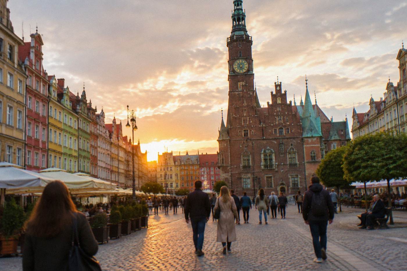 Wroclaw's Market Square at golden hour with colorful townhouses and the Old Town Hall
