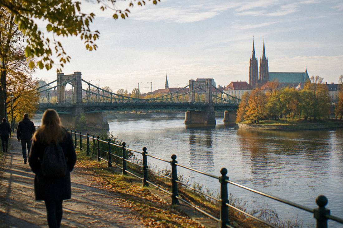 Autumn leaves along the Odra riverbank in Wroclaw with the cathedral in the distance
