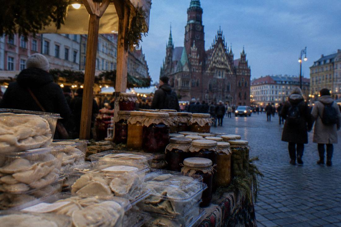 Packaged pierogi and jars of preserves arranged on a market stall