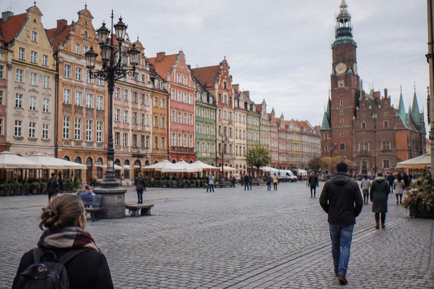 The colorful townhouses of Wroclaw Market Square seen across the open cobblestone square in soft morning light