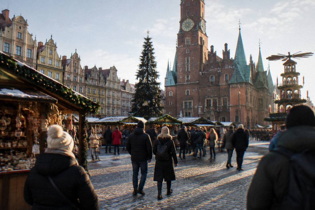 Wroclaw Market Square in winter with a Christmas market occupying the cobblestones in front of the Old Town Hall