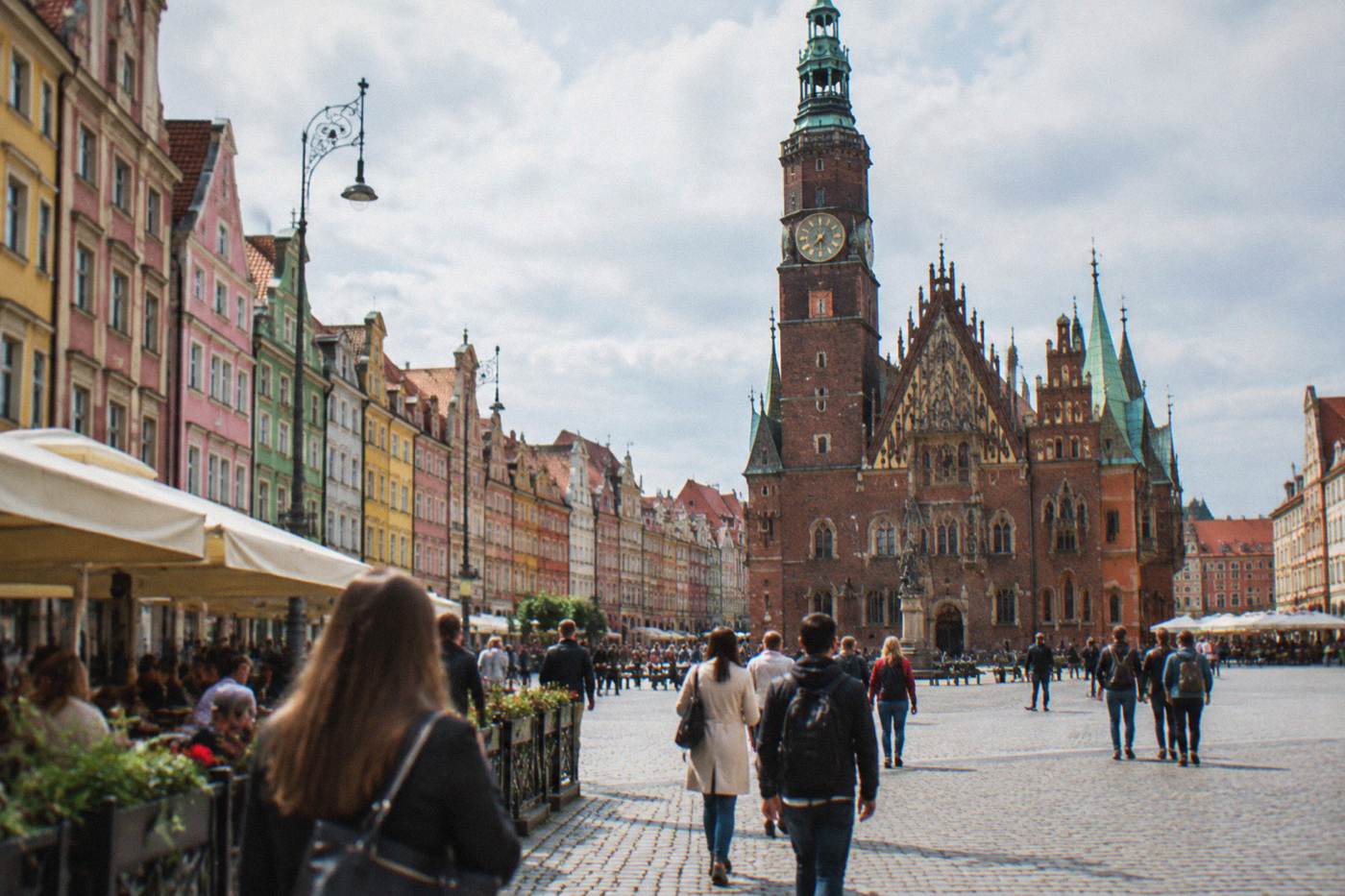 Wroclaw Market Square on a bright day with colorful townhouses and the Gothic town hall