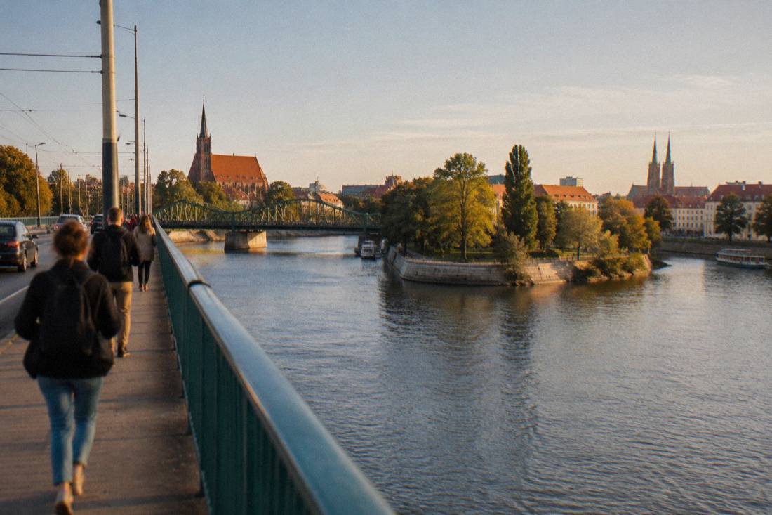 The Odra river flowing past buildings and bridges in central Wroclaw on a clear day