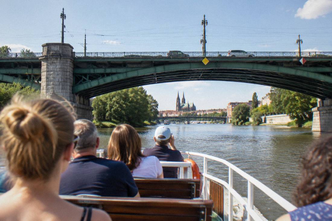 Tourists on a small passenger boat passing under one of Wroclaw's river bridges