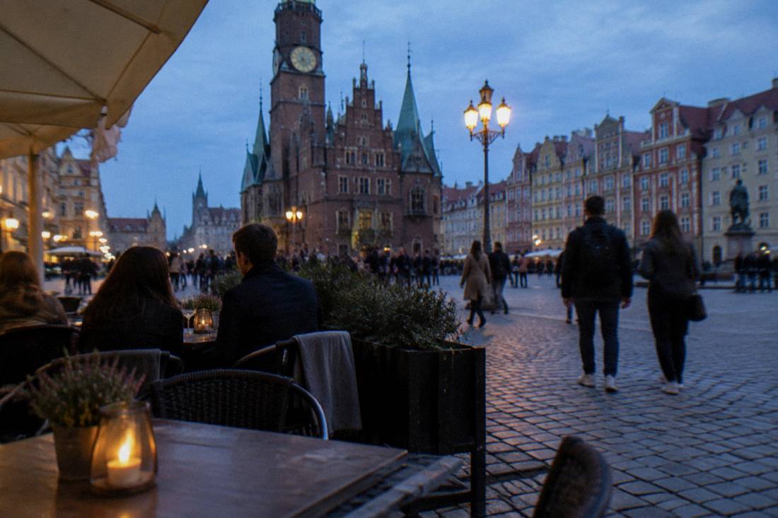 A market square terrace restaurant with tables and chairs on a cobbled square