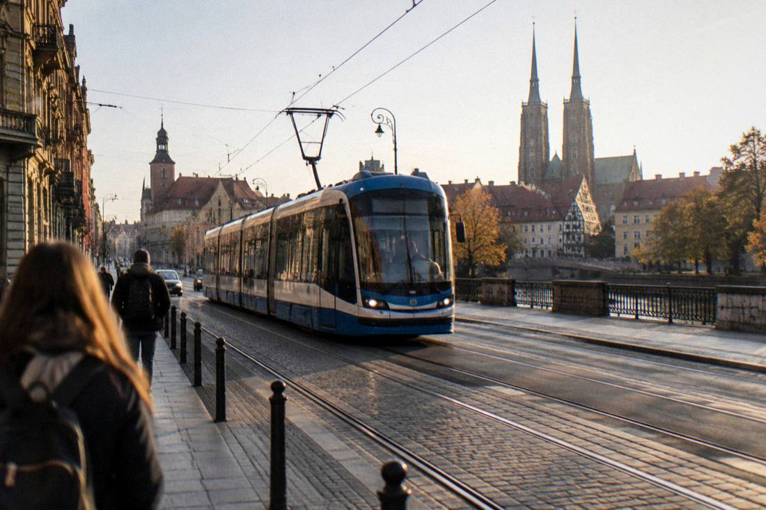 A modern tram moving along a street in central Wroclaw