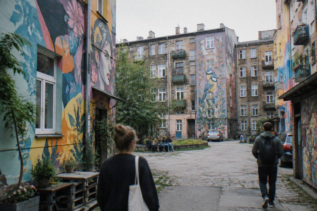 A colorful painted courtyard with murals on old apartment buildings in the Nadodrze district of Wroclaw