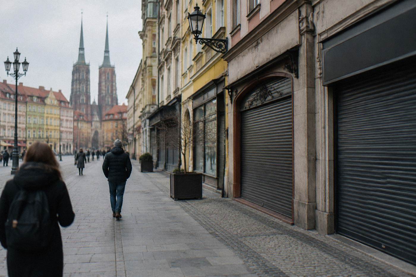 A quiet shopping street in central Wroclaw with closed shutters on a Sunday morning