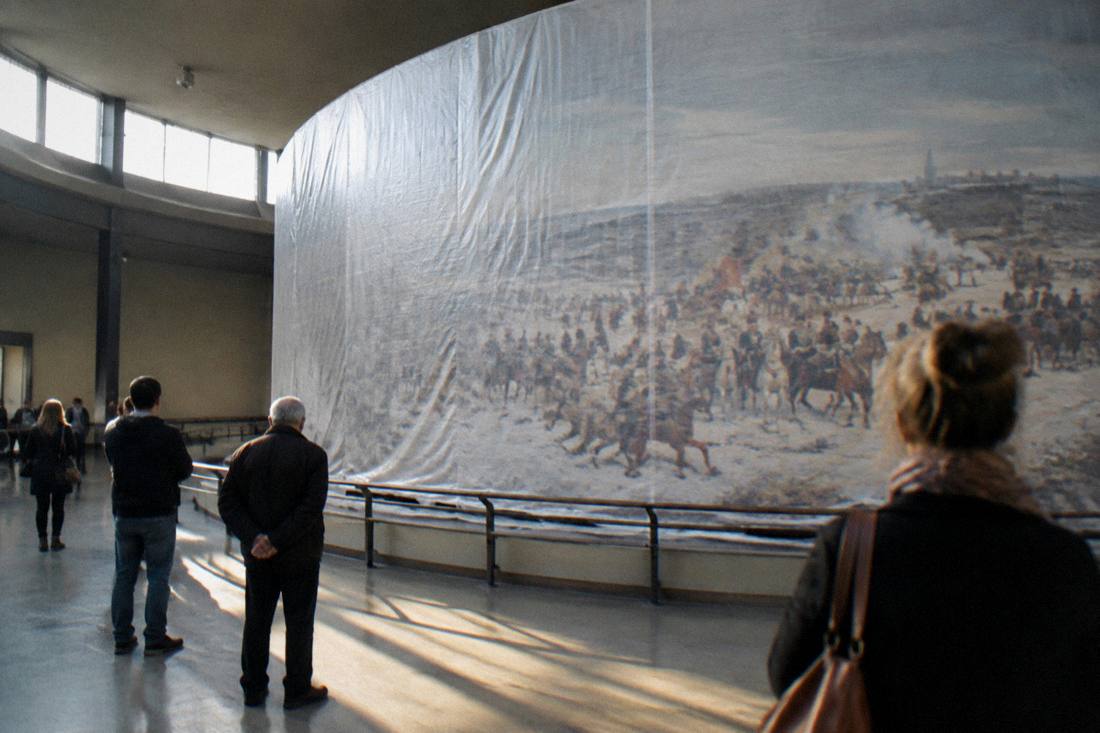 Visitors viewing the wrapped Panorama Raclawicka painting in its rotunda