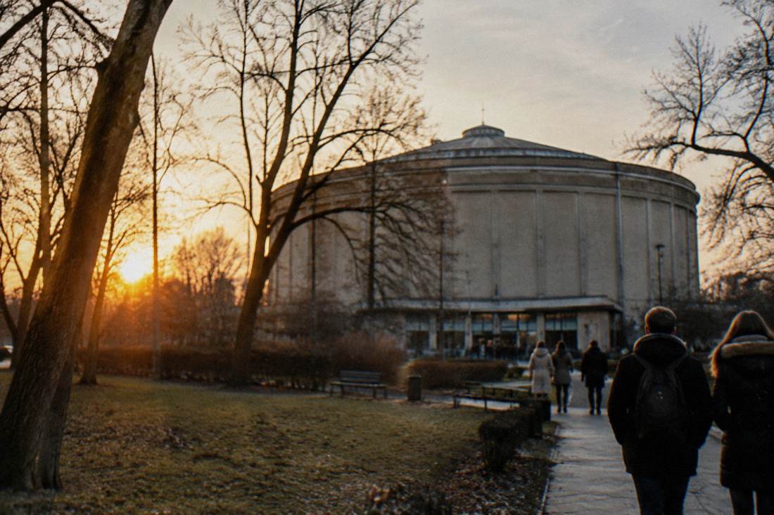 A circular rotunda building housing a panoramic painting, seen from a park with bare winter trees