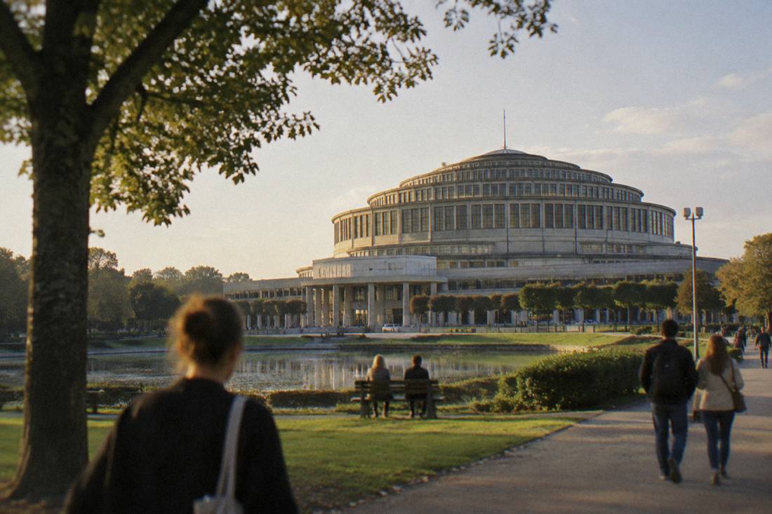The large domed roof of Centennial Hall seen from the surrounding parkland in daylight