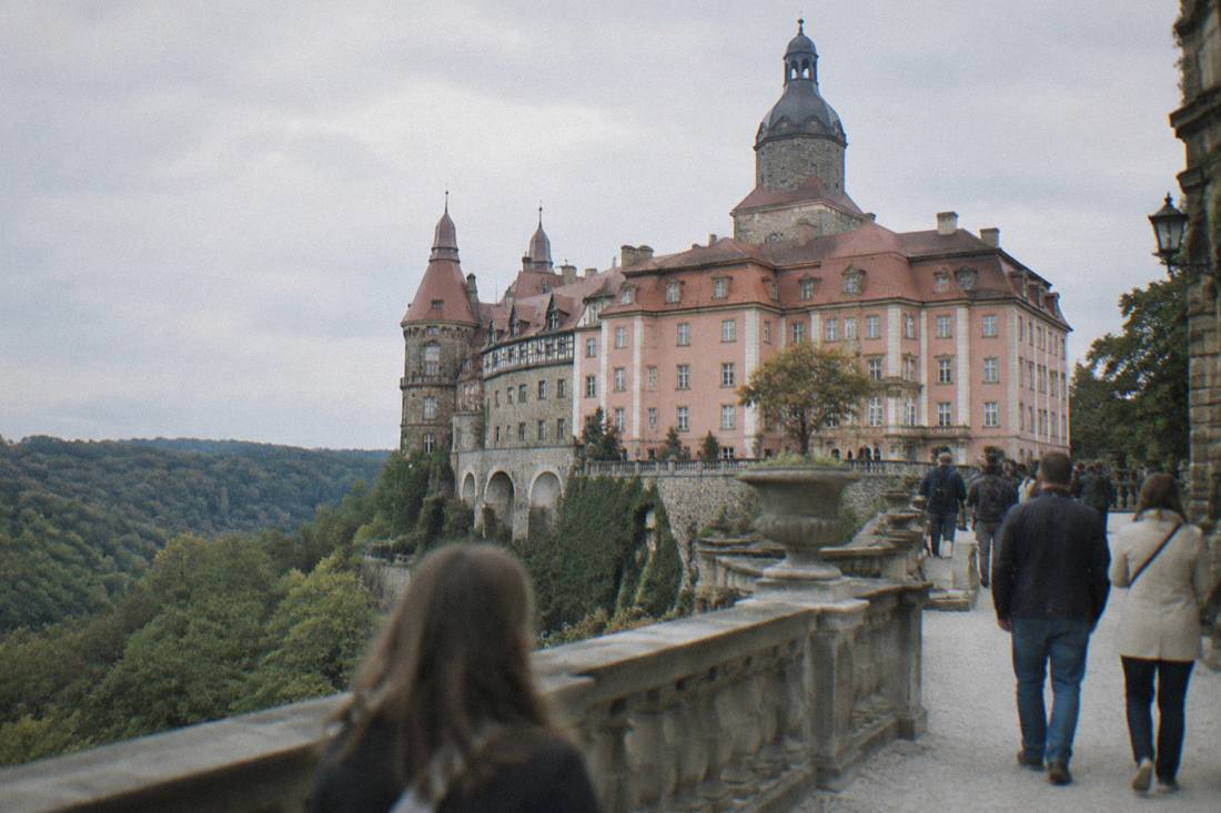 The large terrace and towers of Ksiaz Castle above its wooded grounds in Lower Silesia