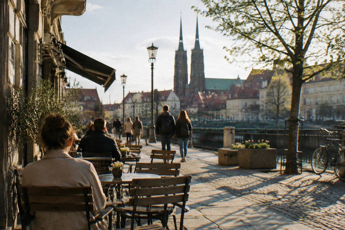 Spring sunlight on a Wroclaw street with outdoor cafe tables