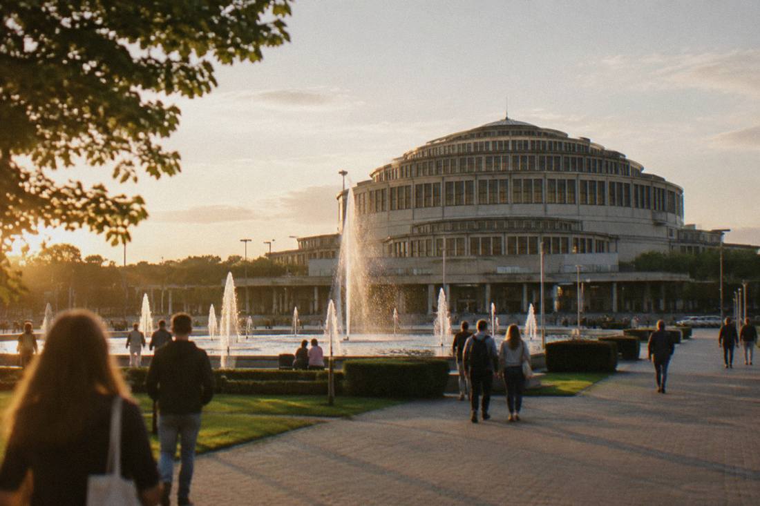 The large domed exterior of Centennial Hall in Wroclaw seen across an open plaza with fountains
