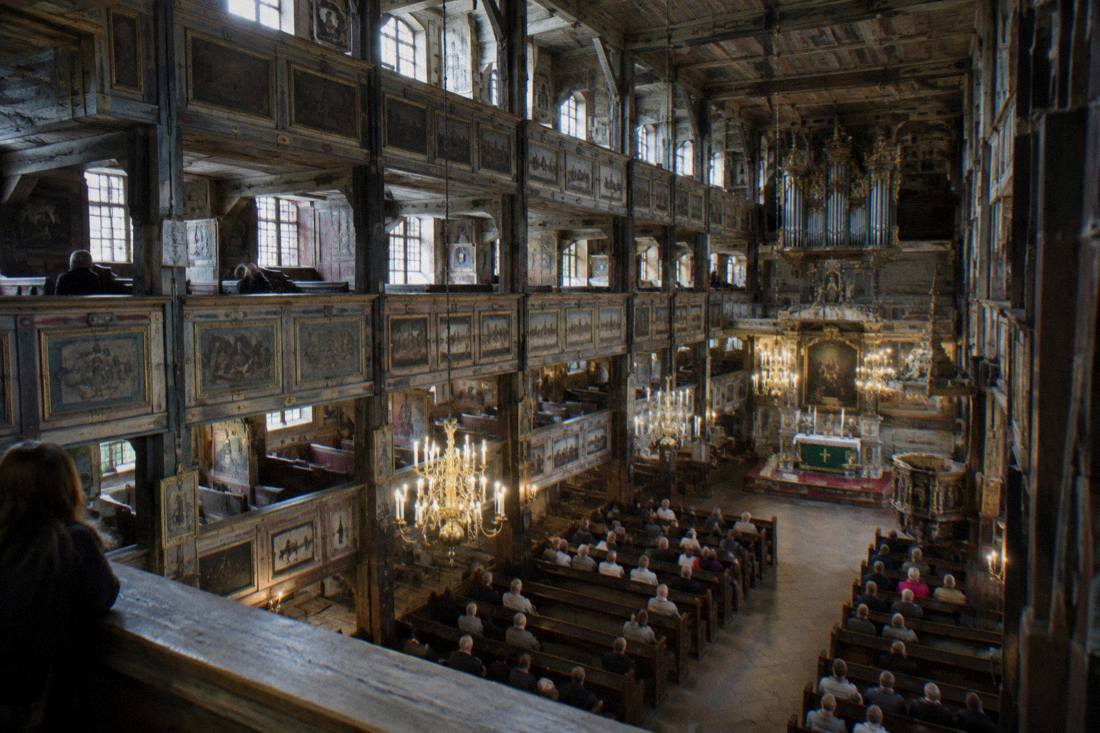 The vast timber interior of the Church of Peace in Swidnica photographed from the gallery level