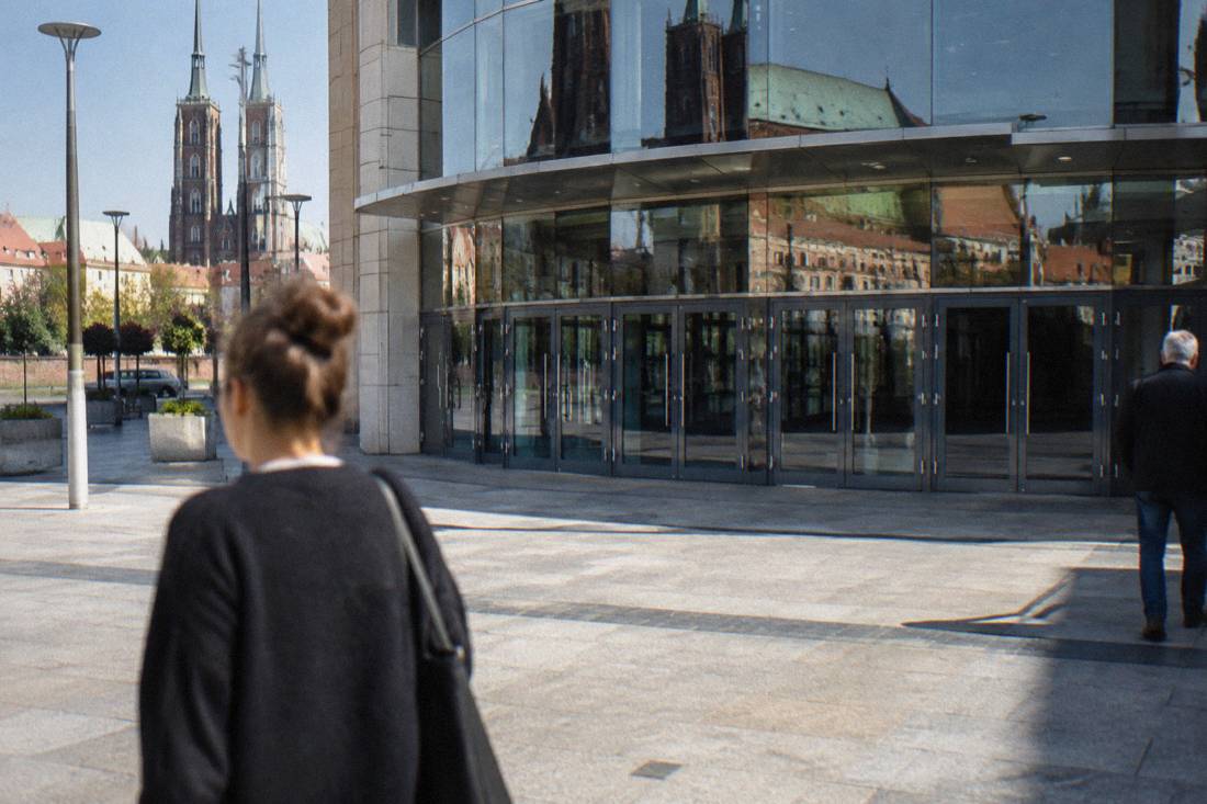 A closed shopping mall entrance in Wroclaw with the doors shut on a quiet Sunday