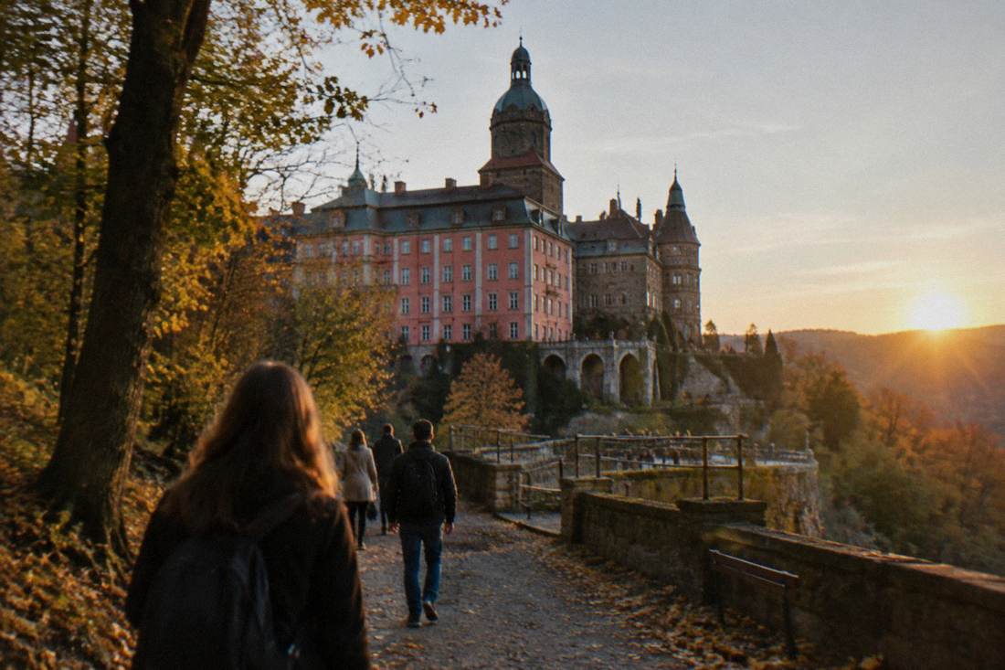 Forest walking path leading toward the terraces of Ksiaz Castle in autumn