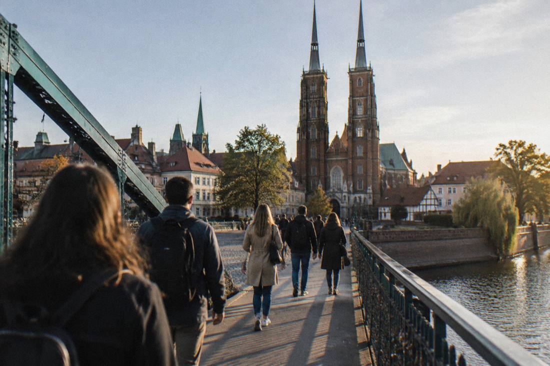 Tourists crossing a bridge onto Ostrow Tumski cathedral island in Wroclaw