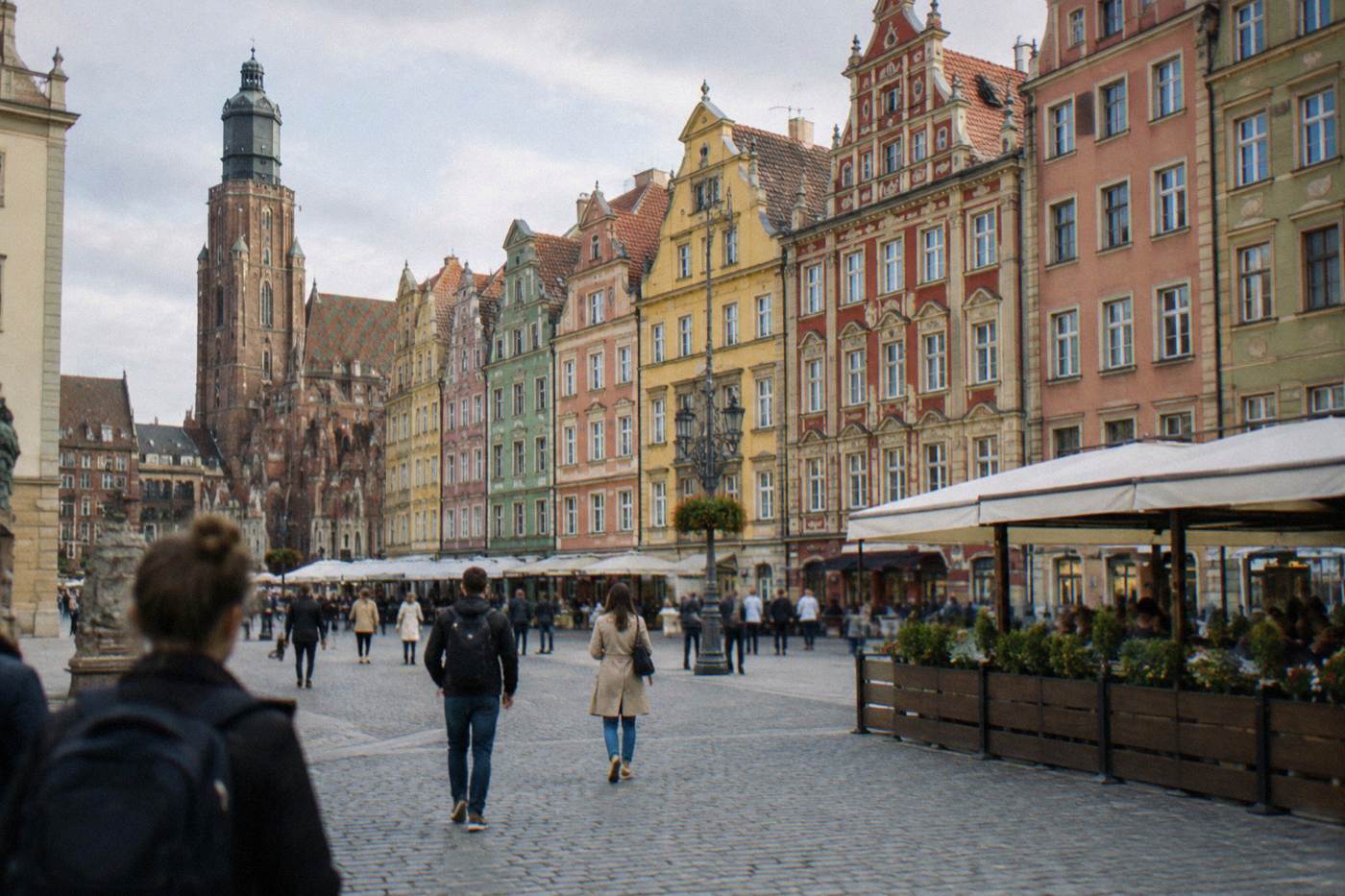The colorful painted townhouses of Wroclaw Market Square seen from ground level on a bright day