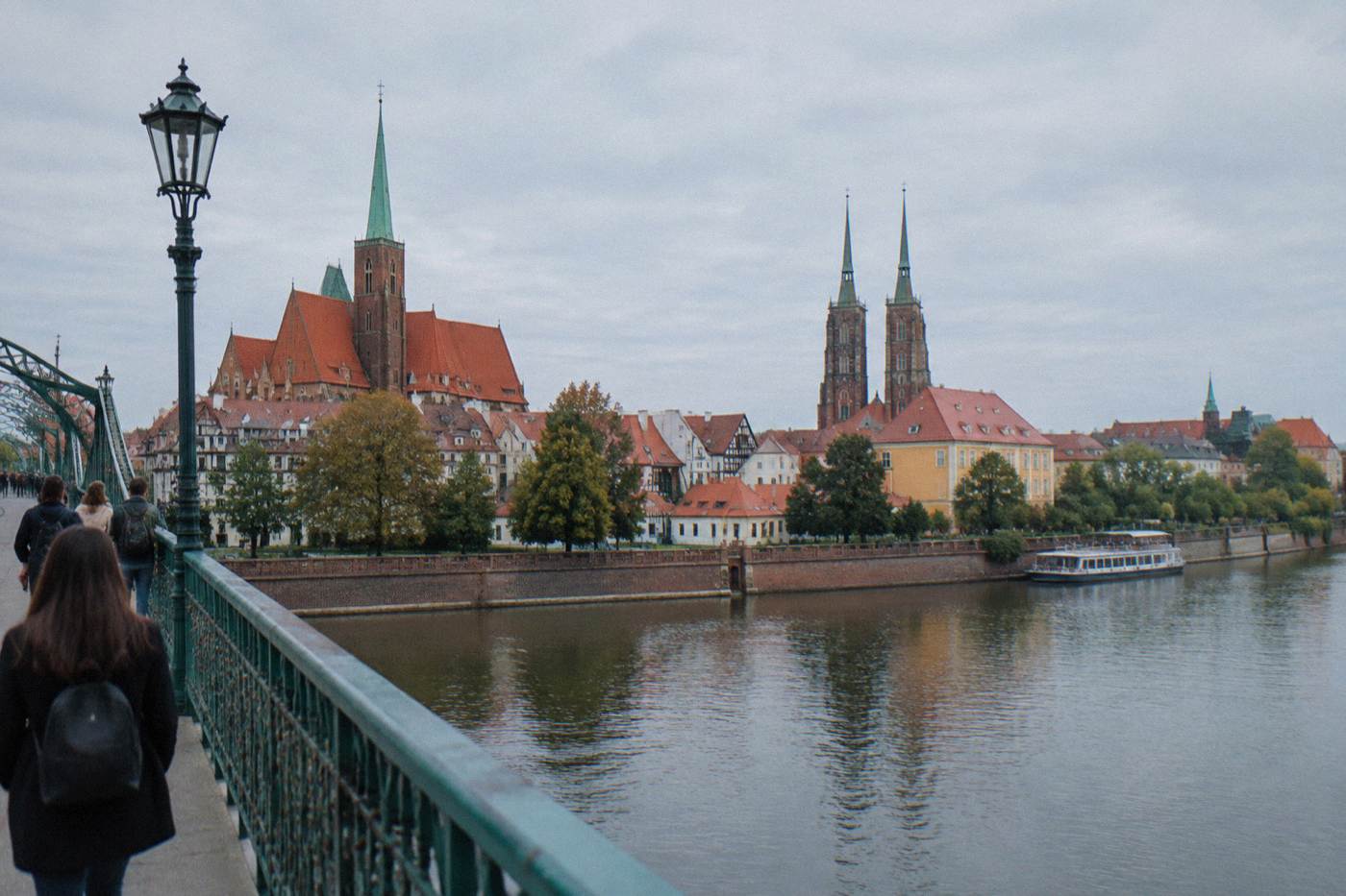 Two river islands and old church towers seen across the water in Wroclaw at golden hour